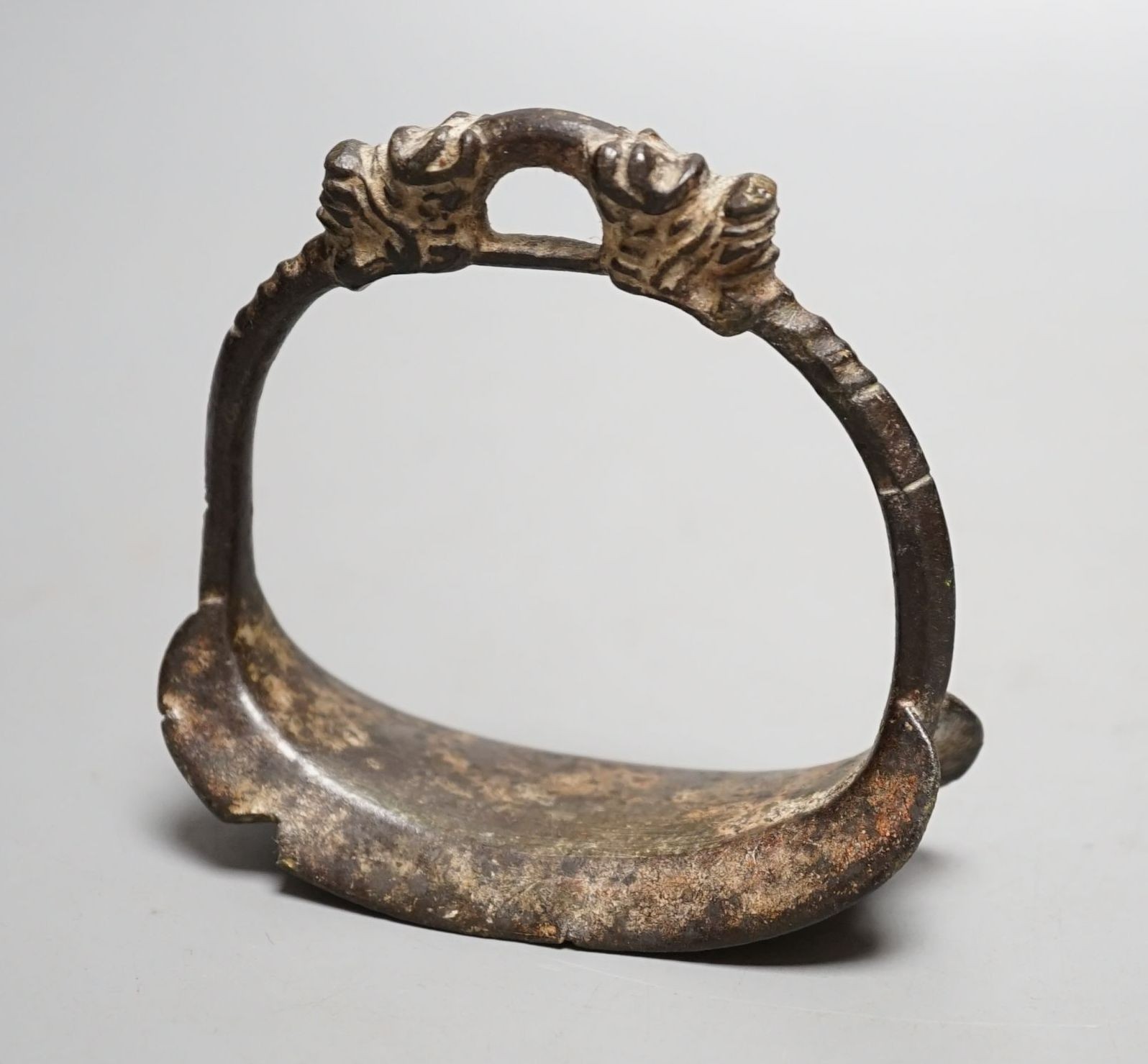 A Chinese archaic (?) bronze stirrup, 10 cms high.